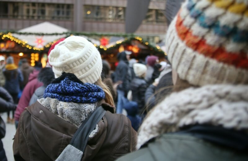 A group of people standing around a market
