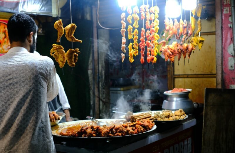 A man standing in front of a buffet filled with food